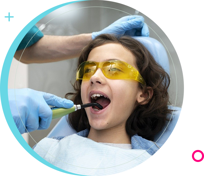 A woman is getting her teeth cleaned by an dentist.