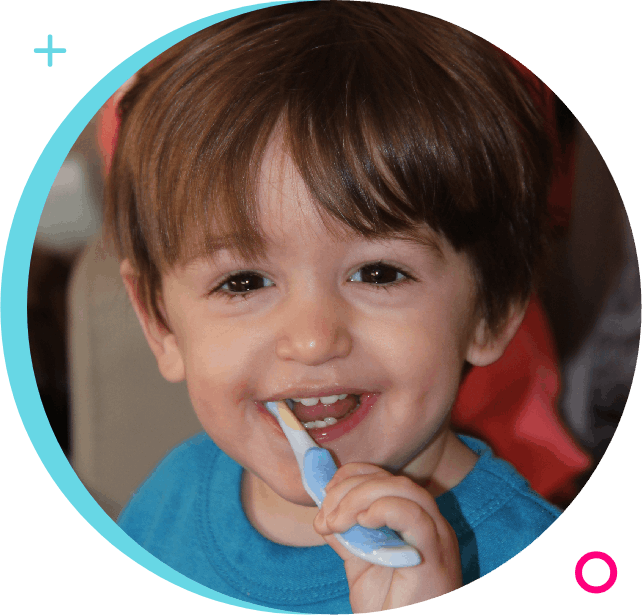 A young boy is brushing his teeth with an electric toothbrush.