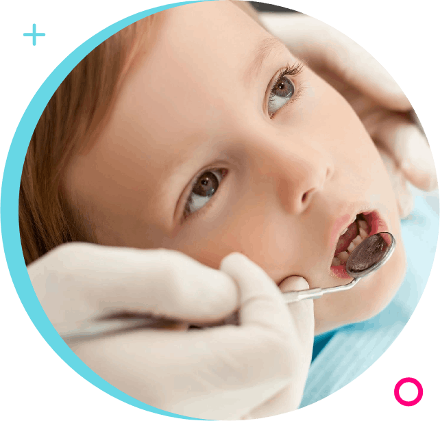 A child is getting his teeth checked by an dentist.